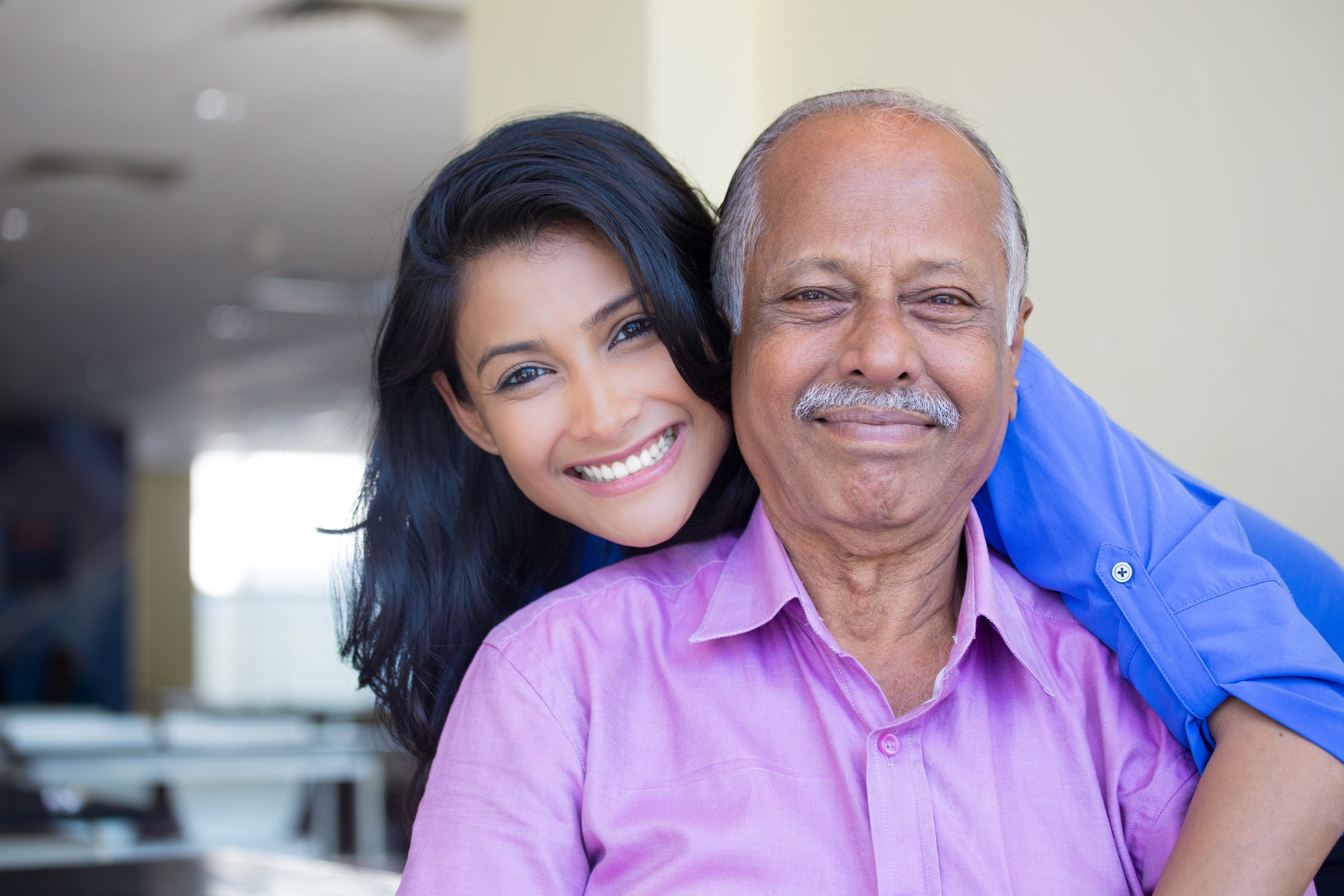 Closeup portrait, family, young woman in blue shirt holding older man in pink collar button
